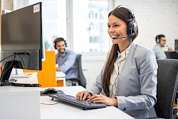 Female customer servcie agent wearing headset and smiling