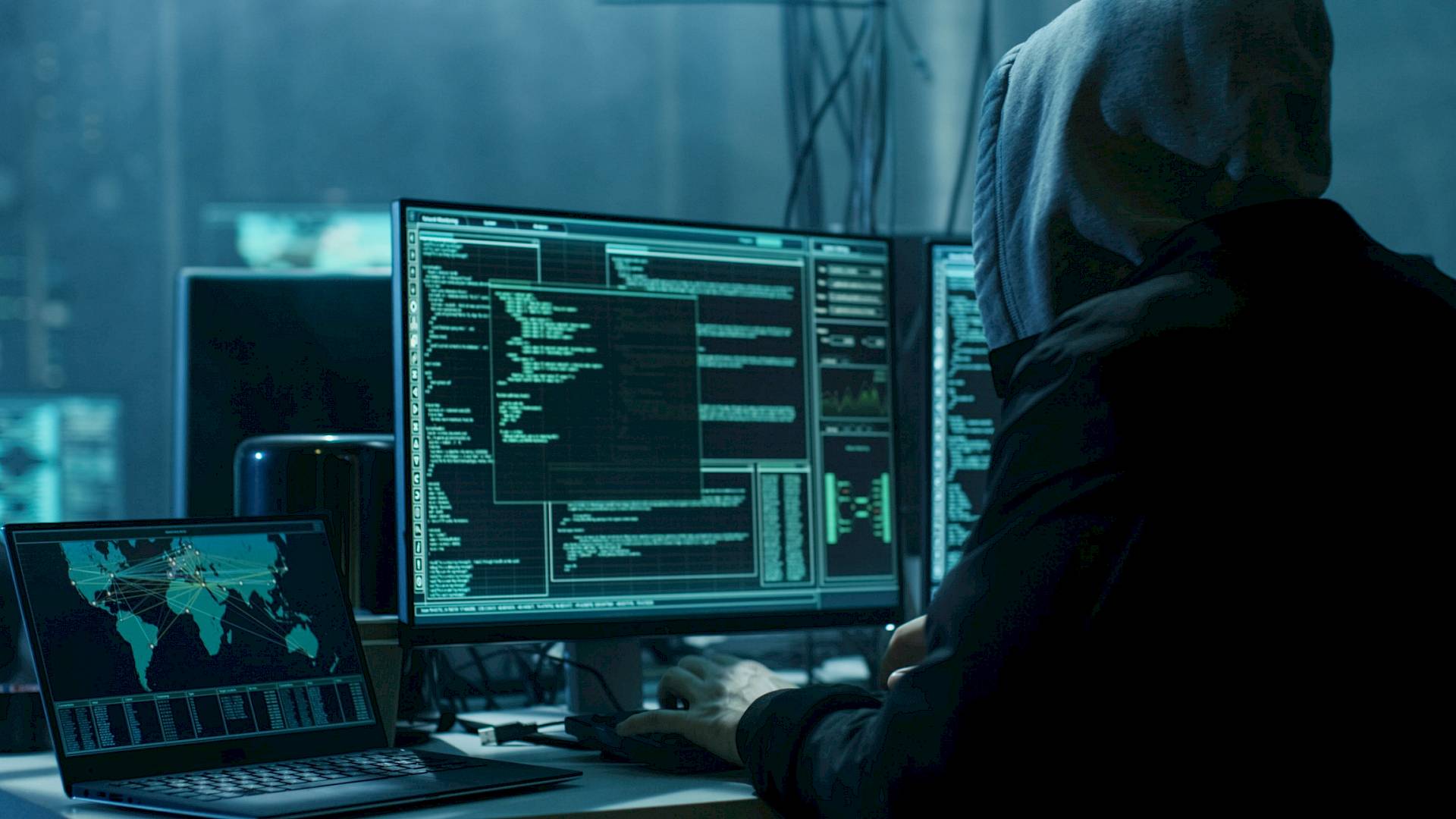 Cyber criminal using a laptop