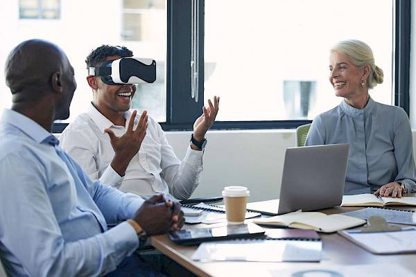 Team discussion with a man wearing a VR headset
