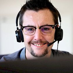 Customer services agent smiling wearing a headset