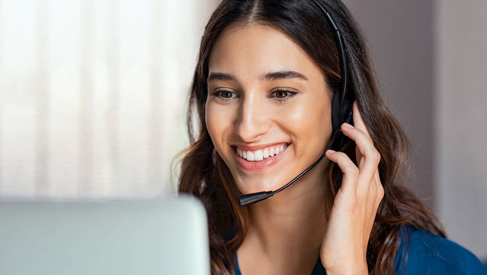 Female professional with headset at a computer