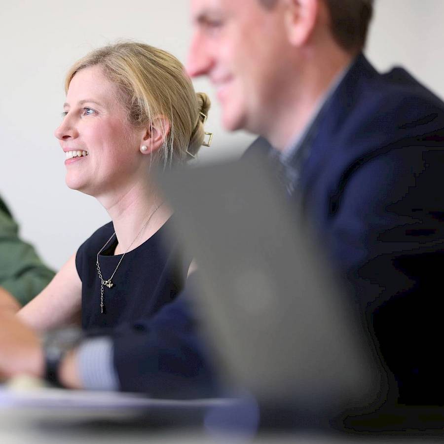 Male and female professional smiling in meeting