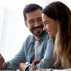 Female and male colleagues smiling