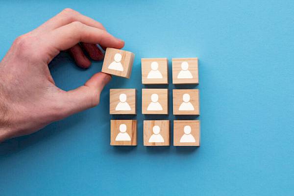 Wooden blogs with white people icons on representing a team