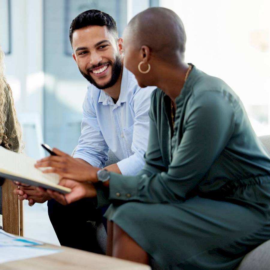 Male and female professional smiling in meeting