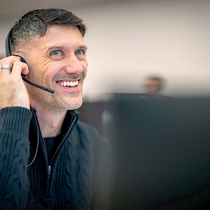 Professional male smiling wearing headset on a call