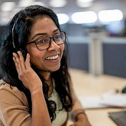female smiling wearing telephone headset